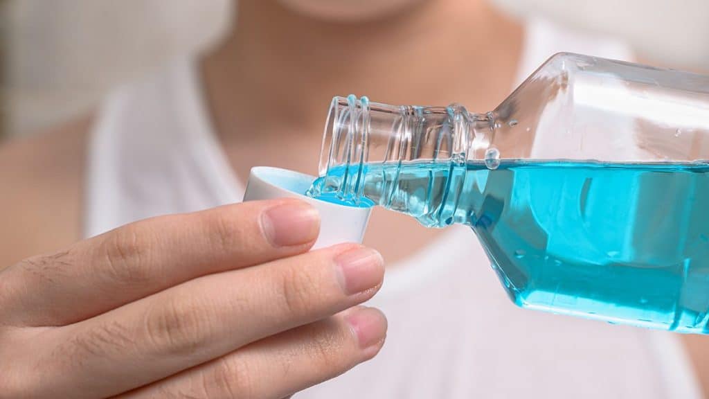 Deerfield Beach, FL resident pouring mouthwash