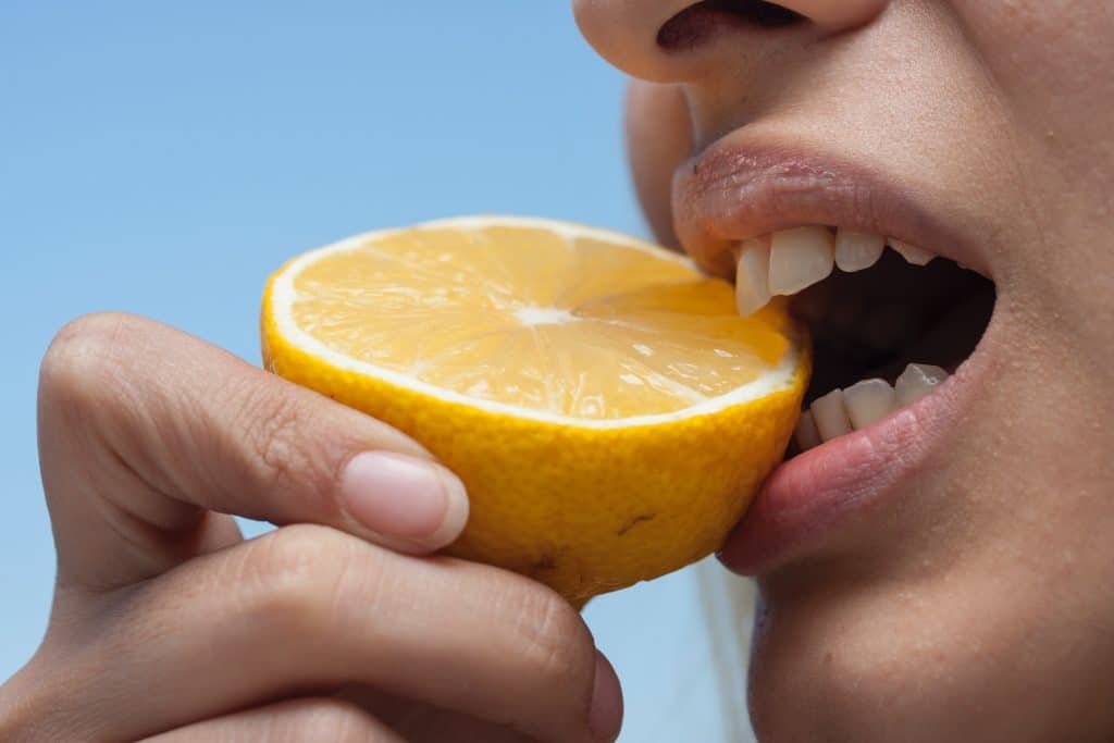 Woman testing her strong tooth enamel