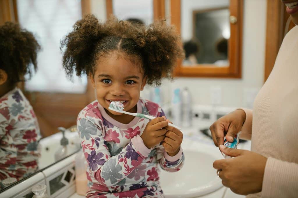 Young girl brushing her teeth